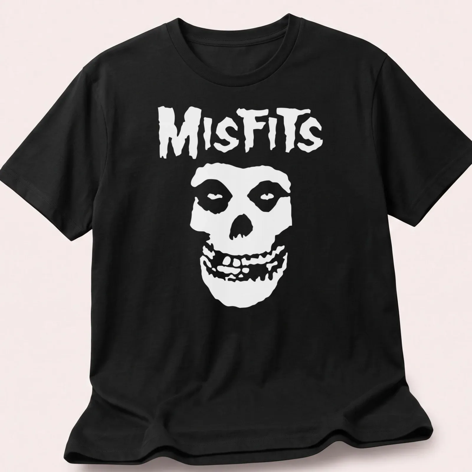 Bold graphic of a skull with the word Misfits in black and white. — printed on a unisex t-shirt