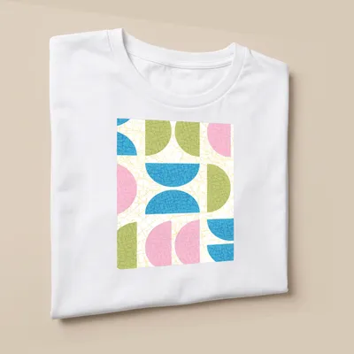 T-shirt featuring a textured pattern of semicircle shapes in various colors. — printed on a unisex t-shirt (angled view)