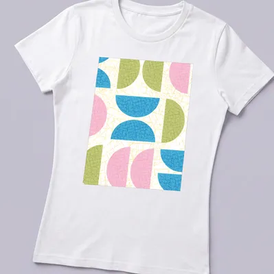 T-shirt featuring a textured pattern of semicircle shapes in various colors. — printed on a women's shirt