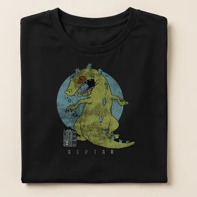 Cartoon monster playfully destroying city buildings in yellow and blue — printed on a women's shirt