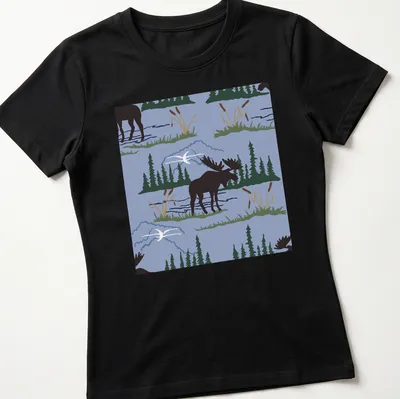 Illustration of a moose in a nature pattern against an ice blue background. — printed on a women's shirt