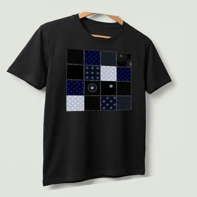 Modern geometric patchwork pattern tee inspired by the night sky in navy and light blue. — printed on a unisex t-shirt (angled view)