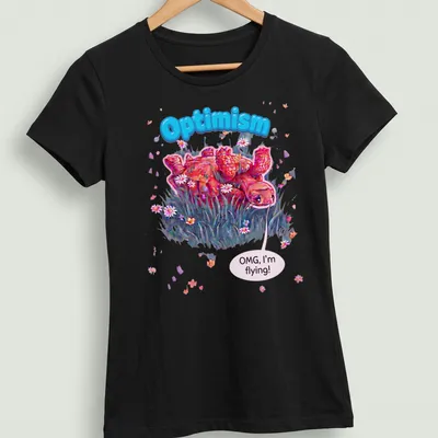 Colorful cartoon turtle with text 'Optimism OMG, I'm flying!' in pink, blue, and green — printed on a women's shirt