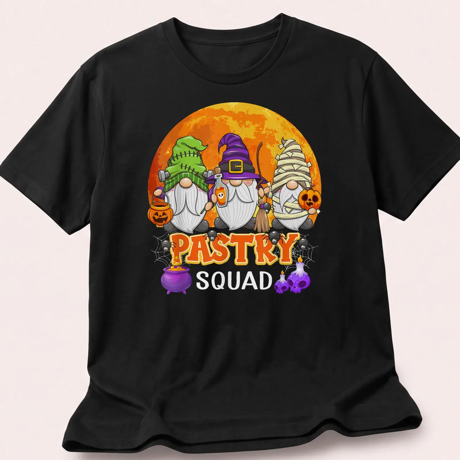 Cartoonish Halloween gnomes with Pastry Squad text in various colors — printed on a unisex t-shirt