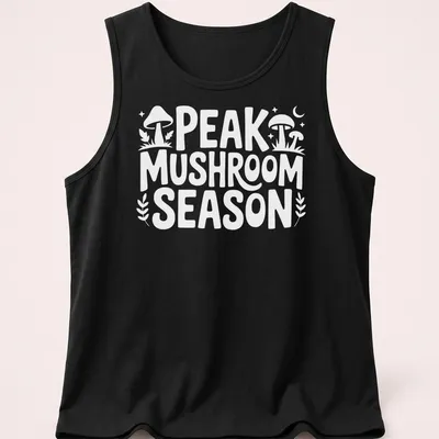 Bold typography Peak Mushroom Season t-shirt featuring mushrooms in green and brown — printed on a tank top