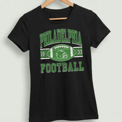 Vintage distressed Philadelphia Football 1933 T-shirt with football helmet and ball graphic — printed on a women's shirt