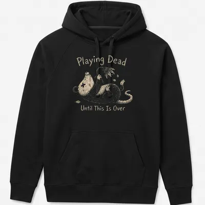 Whimsical illustration of an opossum with the text 'Playing Dead Until This Is Over' in soft colors — printed on a unisex hoodie