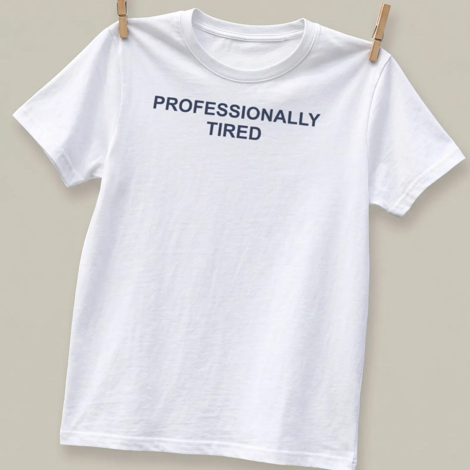 Sarcastic t-shirt with the text 'PROFESSIONALLY TIRED' in bold letters — printed on a unisex t-shirt