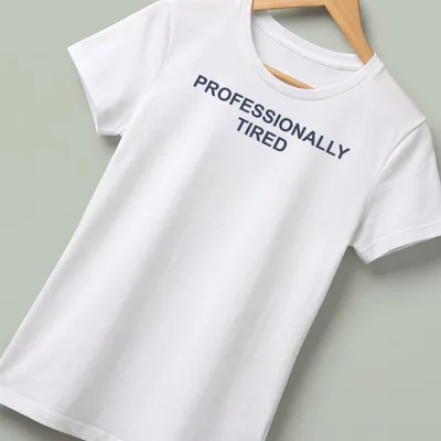 Sarcastic t-shirt with the text 'PROFESSIONALLY TIRED' in bold letters — printed on a women's shirt