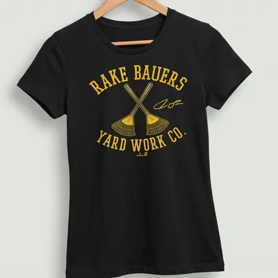 Bold vintage graphic tee with crossed rakes and yard work company text — printed on a women's shirt