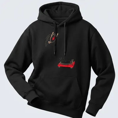 Cartoonish happy vinyl record jumping onto a turntable in red, beige, and white — printed on a unisex hoodie