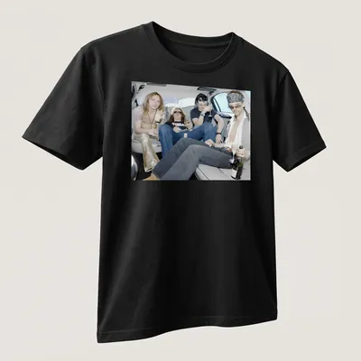Photographic print of rock band members celebrating in a limousine, with vibrant colors — printed on a unisex t-shirt (angled view)