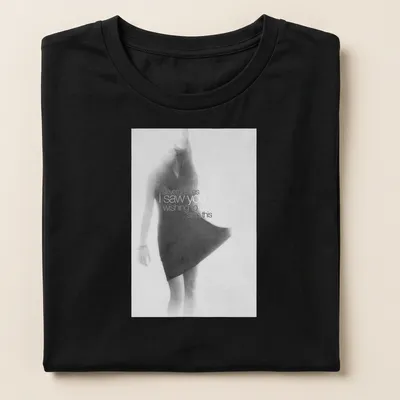 Soft focus monochrome T-shirt featuring a female figure in motion and expressive text — printed on a women's shirt