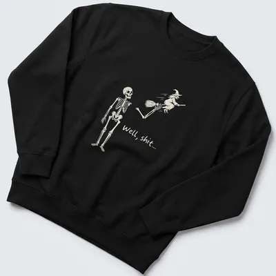 A humorous line-art print of a skeleton reacting to a flying witch with the text 'Well, shit...' — printed on a unisex sweatshirt