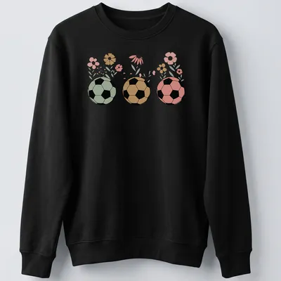 Retro floral design featuring soccer balls and wildflowers in various colors. — printed on a unisex sweatshirt