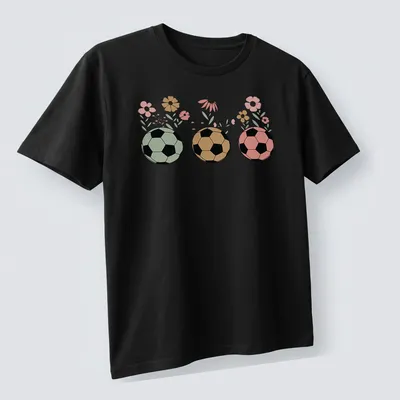 Retro floral design featuring soccer balls and wildflowers in various colors. — printed on a unisex t-shirt (angled view)