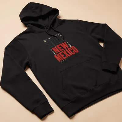 Vintage distressed t-shirt featuring the phrase 'Still New Mexico Not For Rebrand' in bold lettering. — printed on a unisex hoodie