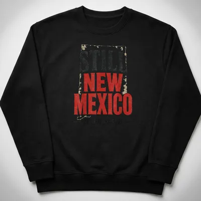 Vintage distressed t-shirt featuring the phrase 'Still New Mexico Not For Rebrand' in bold lettering. — printed on a unisex sweatshirt