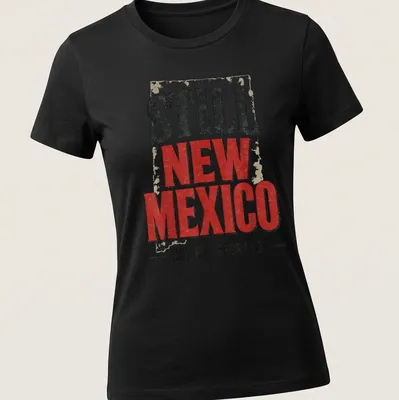Vintage distressed t-shirt featuring the phrase 'Still New Mexico Not For Rebrand' in bold lettering. — printed on a women's shirt