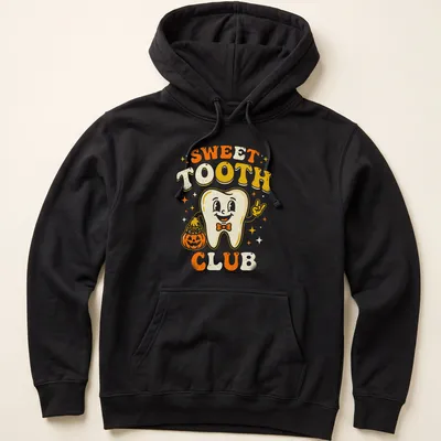 Retro cheerful Halloween T-shirt with a smiling tooth character beside a pumpkin — printed on a unisex hoodie