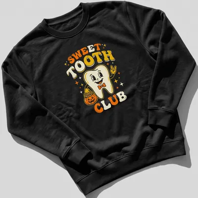 Retro cheerful Halloween T-shirt with a smiling tooth character beside a pumpkin — printed on a unisex sweatshirt