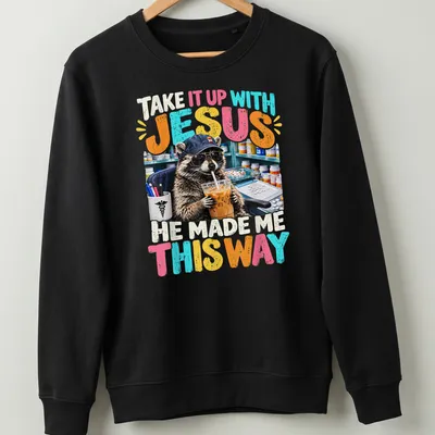 Colorful cartoon raccoon with humorous text, playful design — printed on a unisex sweatshirt