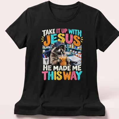 Colorful cartoon raccoon with humorous text, playful design — printed on a women's shirt