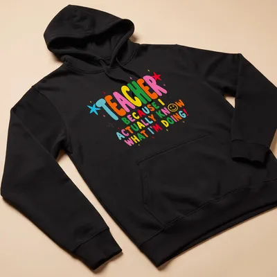 Colorful teacher-themed t-shirt with playful text and stars — printed on a unisex hoodie