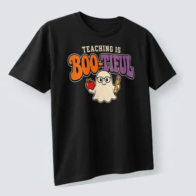 Kawaii ghost holding an apple and pencil with the text 'Teaching Is Boo-Tiful' in colorful design. — printed on a unisex t-shirt (angled view)