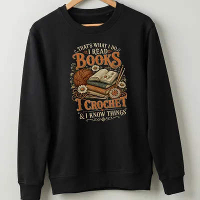 Vintage illustration tee featuring books and crochet imagery with warm tones — printed on a unisex sweatshirt