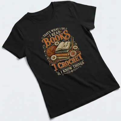 Vintage illustration tee featuring books and crochet imagery with warm tones — printed on a women's shirt