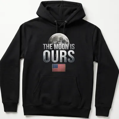 Graphic t-shirt featuring the phrase 'The Moon Is Ours' with a moon and American flag — printed on a unisex hoodie