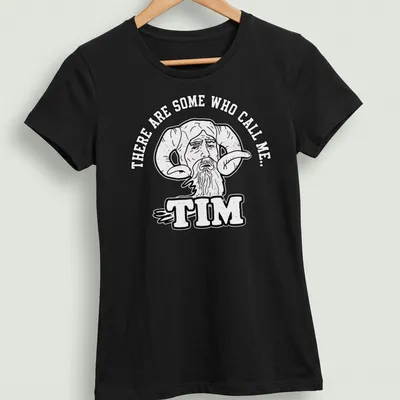 Bold cartoon of a bearded man with ram horns and humorous text — printed on a women's shirt