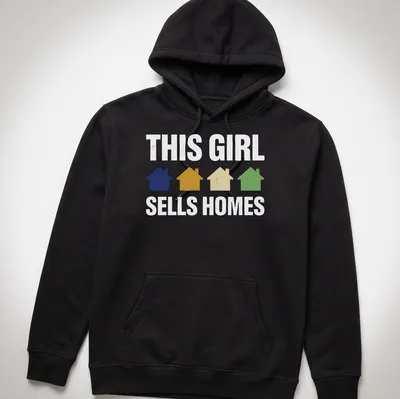 Retro t-shirt with houses and playful text saying 'This Girl Sells Homes' in cheerful colors — printed on a unisex hoodie