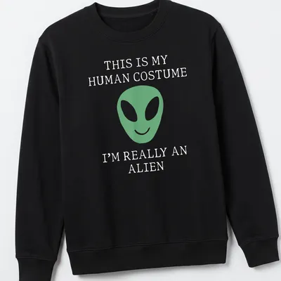 Playful t-shirt featuring a green alien face and humorous text about human costumes. — printed on a unisex sweatshirt
