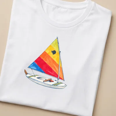 Watercolor print of a vintage sunfish sailboat with a rainbow sail — printed on a women's shirt