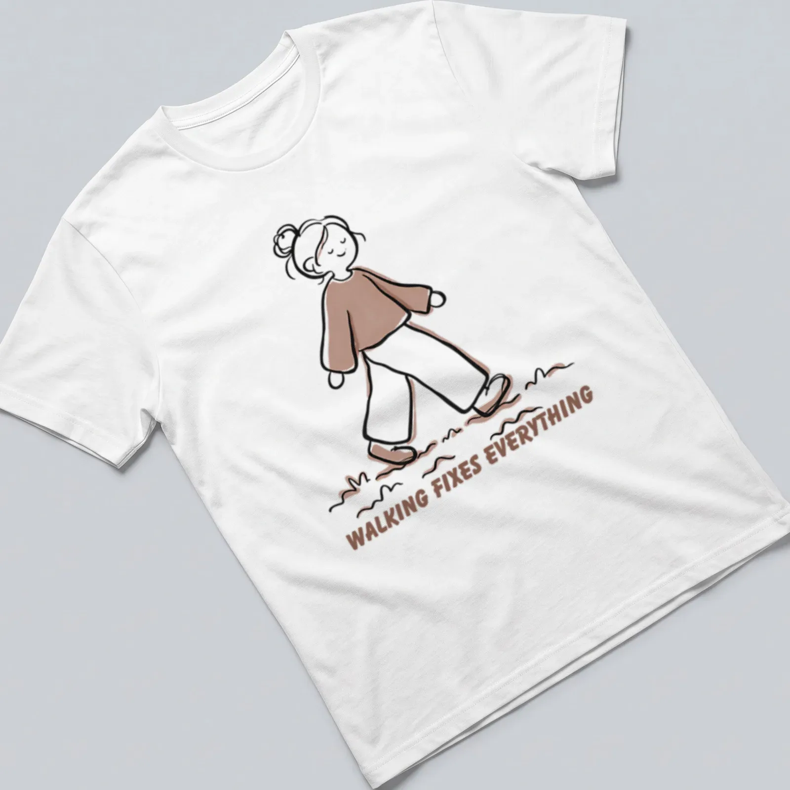 Cute walking girl line-art t-shirt with text 'Walking Fixes Everything' in brown and beige — printed on a unisex t-shirt