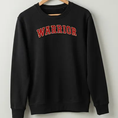 Distressed graphic tee featuring bold 'WARRIOR' text in red, black, and white — printed on a unisex sweatshirt