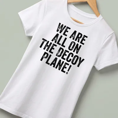 Vintage political humor shirt with text: WE ARE ALL ON THE DECoy PLANE! — printed on a women's shirt