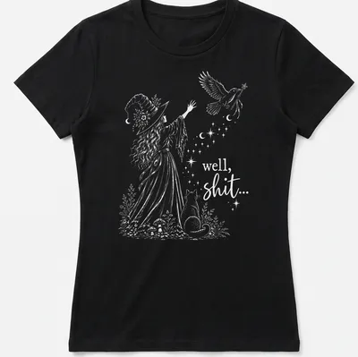 Whimsical illustration of a witch with cat and bird, featuring humorous text — printed on a women's shirt