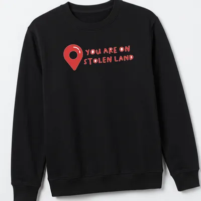 Bold text design on a shirt with a map pin graphic, red and white colors — printed on a unisex sweatshirt