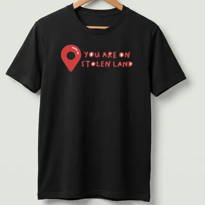 Bold text design on a shirt with a map pin graphic, red and white colors