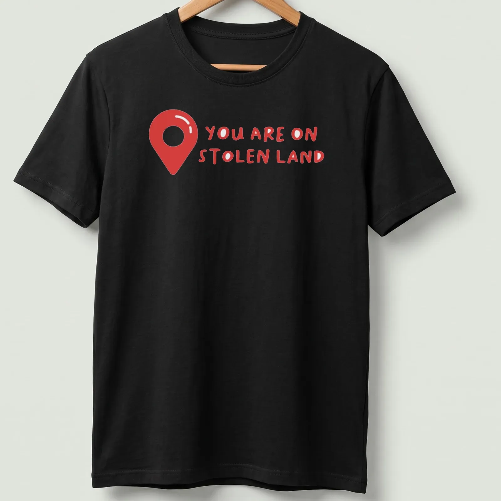 Bold text design on a shirt with a map pin graphic, red and white colors — printed on a unisex t-shirt